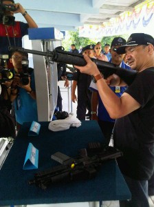 Hishammuddin with a sniper rifle