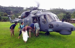 Super Lynx M502-03 sending food items to one of the areas affected by floods in December 2015. TLDM picture.