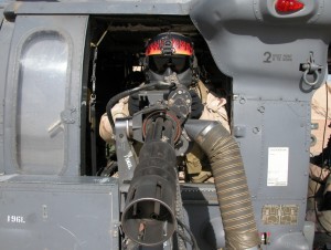 A gunner on a US Army Blackhawk. Note the helmet and the maxillofacial shield.