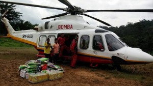 Bomba AW139 9M-BOD carrying supplies to an Orang Asli village during the massive floods in late 2014. Bomba picture.