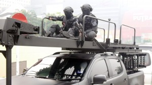 UTK operators sitting on top of the assault ladder of their Hilux.