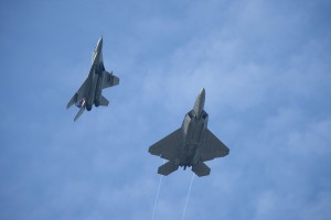 Mig-29N M43-03 flies together with a USAF F-22 Raptor at Cope Taufan 2014. 03 is one of the most pictured Fulcrum instantly reconigsable for its colourful fins simbolising the 17th Squadron,