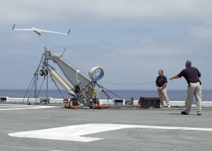 A Scan Eagle launches from a pneumatic wedge catapult launcher on the flight deck aboard the amphibious assault ship USS Saipan. US Navy picture.