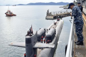 Chief Engineman Bernard Paje watches as guided missile submarine USS Ohio (SSGN 726) gets underway after being moored alongside submarine tender USS Emory S.Land (AS 39 ), at RMN Kota Kinabalu naval base on Teluk Sepanggar. US Navy.