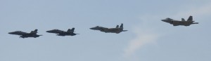 Two Royal Malaysian Air Force F/A-18s, a Massachusetts Air National Guard F-15 Eagle and a Hawaii Air National Guard F-22 Raptor perform a fly-by after a successful sortie during Cope Taufan, P. U. Butterworth, Malaysia, June 16, 2014.  (U.S. Air Force Photo By Tech Sgt. Andrew L. Jackson / Released)