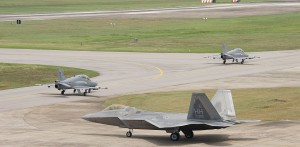 Two Royal Malaysian Air Force BAE Hawk and an F-22 Raptor from Hawaii National Guard 199th Fighter Squadron and U.S. Air Forces 19th FS taxis during Cope Taufan 2014, P.U. Butterworth, Malaysia June 11, 2014.  USAF picture
