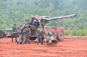 The crew of a G5 155mm howitzer prepping the gun for firing.