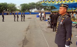 A newly minted RMAF pilot waits for his turn to get into the parade as his colleague is presented his wings.