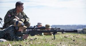 A South Korean soldiers test out the AX sniper rifle under the watchful eye of the Malaysian sniper.