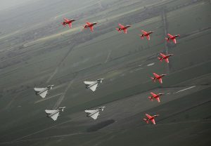 The Royal Air Force Aerobatic Team (RAFAT) "The Red Arrows" and Typhoon aircraft are shown flying in formation as part of the 90th Anniversary of the RAF in 2008.