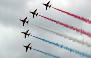 Red Arrows in a perfect formation with the red, white and red smoke 